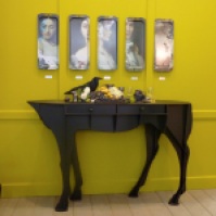 The booth of Ibride from France shows animals and antique influences with trays with portraits.